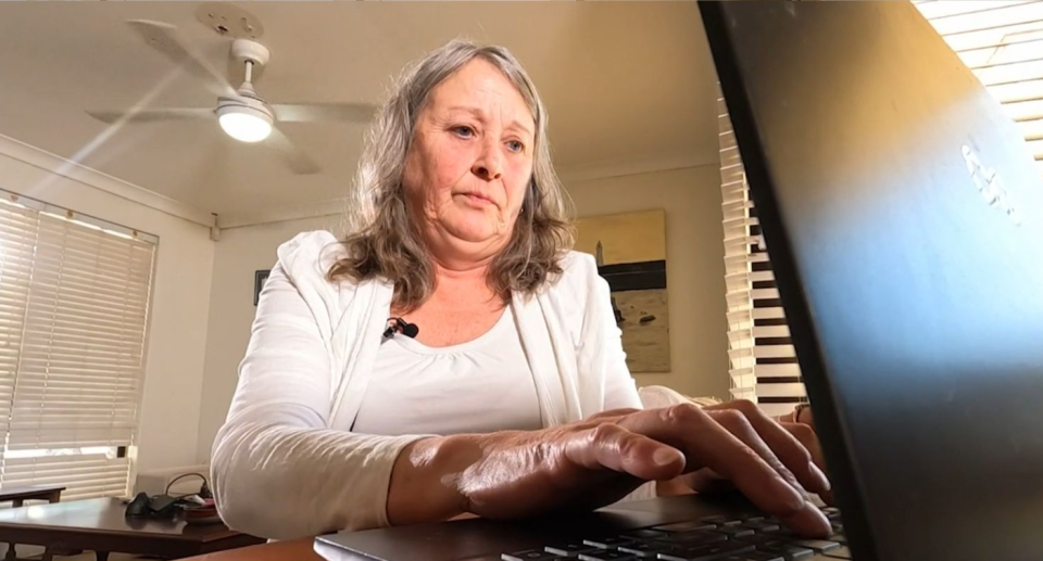 Scam victim Sally Marchant typing on her computer