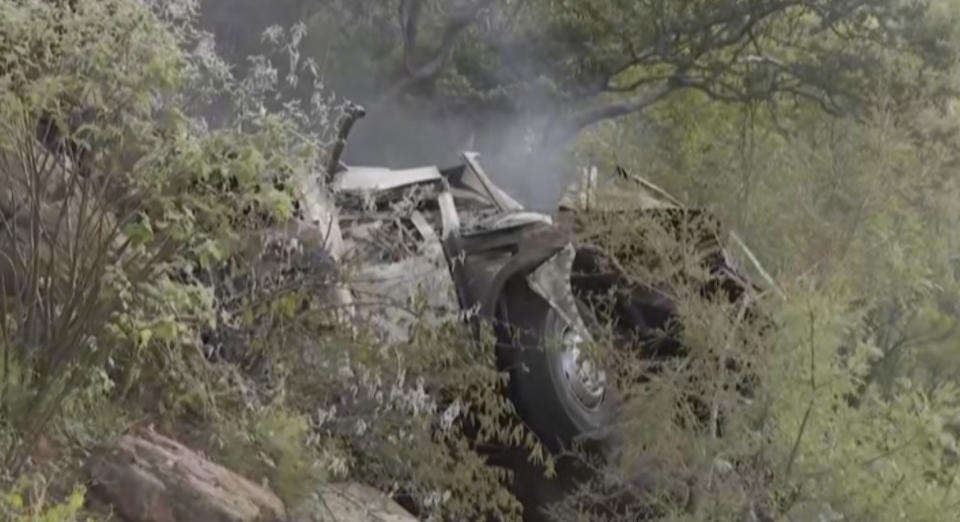 In this image taken from video provided by eNCA, a bus carrying worshippers headed to an Easter festival plunged off a bridge on a mountain pass and burst into flames in Limpopo, South Africa, on Thursday, March 28, 2024, killing multiple people, authorities said. (eNCA via AP)