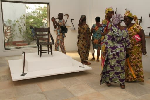 Visitors contemplate artefacts recently returned to Benin and on show at Cotonou's "Petite Mus�e de la Recade