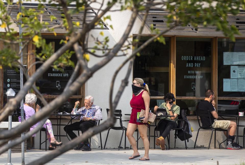 Customers sit outside a Starbucks coffee shop on San Vicente Blvd. in Brentwood.