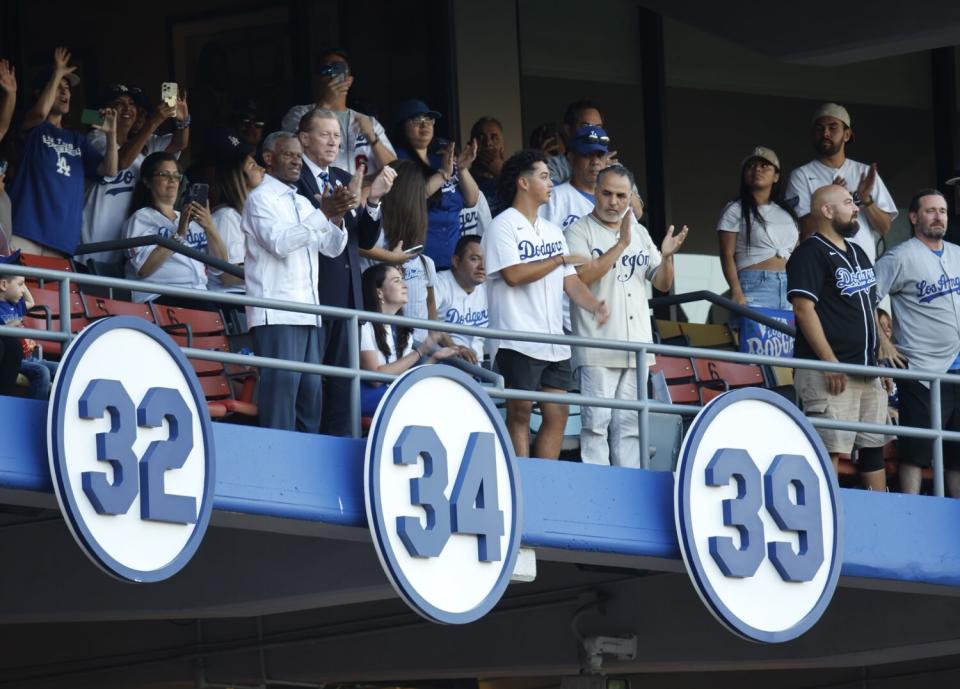 Fans celebrate as Fernando Valenzuela's retired number is revealed during a ceremony at Dodger Stadium.