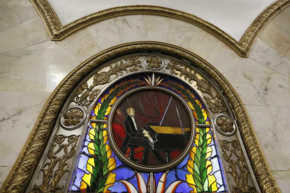 A stained glass panel is seen in Novoslobodskaya metro station, which was built in 1952, in Moscow, August 17, 2013. To step onto the Moscow metro is to step back in time and immerse yourself in a museum rich in architecture and history. Opened in 1935, it is an extravagant gallery of Communist design, featuring Soviet artworks, statues, chandeliers, stained glass and ceiling mosaics. Built under Stalin, the metro now transports 7 to 9 million people a day and costs 30 Rubles, around $1, for a single ride. Picture taken August 17, 2013. REUTERS/Lucy Nicholson (RUSSIA - Tags: TRANSPORT SOCIETY) ATTENTION EDITORS: PICTURE 07 OF 24 FOR PACKAGE 'RIDING THE MOSCOW METRO' SEARCH 'MOSCOW CHANDELIERS' FOR ALL IMAGES