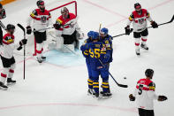 Sweden's team players, centre, celebrate after Marcus Sorensen, centre left, scored his side's second goal during the group A match between Sweden and Austria at the ice hockey world championship in Tampere, Finland, Sunday, May 14, 2023. (AP Photo/Pavel Golovkin)