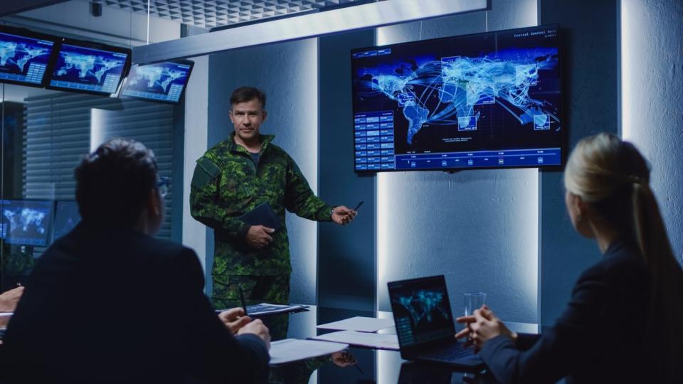 Military personnel using software to make a decision