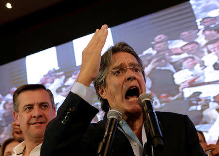 Ecuadorean presidential candidate Guillermo Lasso speaks near vice president candidate Andres Paez while waiting for the results of the national election in a hotel, in Guayaquil, April 2, 2017. REUTERS/Henry Romero