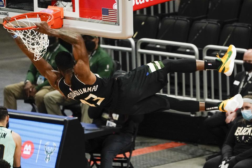 Milwaukee Bucks' Thanasis Antetokounmpo dunks during the first half of an NBA basketball game against the Charlotte HornetsFriday, April 9, 2021, in Milwaukee. (AP Photo/Morry Gash)