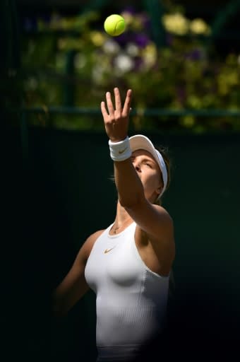 Canada's Eugenie Bouchard tosses the ball to serve