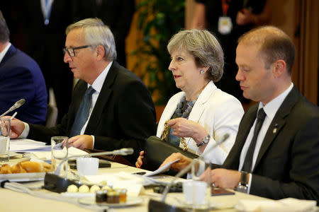 European Commission President Jean-Claude Juncker, British Prime Minister Theresa May (C), and Maltese Prime Minister Joseph Muscat take part in an EU summit in Brussels, Belgium October 20, 2017. REUTERS/Julien Warnand/Pool