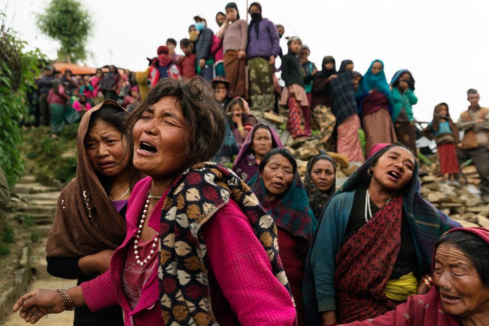 Nepal earthquake. Gumda Village, in Ghorka district. 5 people died and 14 are still missing in landslides. Inhabitants salvaging building materials from their destroyed houses. Funeral of Rejina Gurung, 3 who was just discovered buried in the rubble. Her mother, Bishnu Gurung, weeping in mourning. Rejina's father, Chabilal Gurung is a guest worker in Malaysia. by James Nachtwey