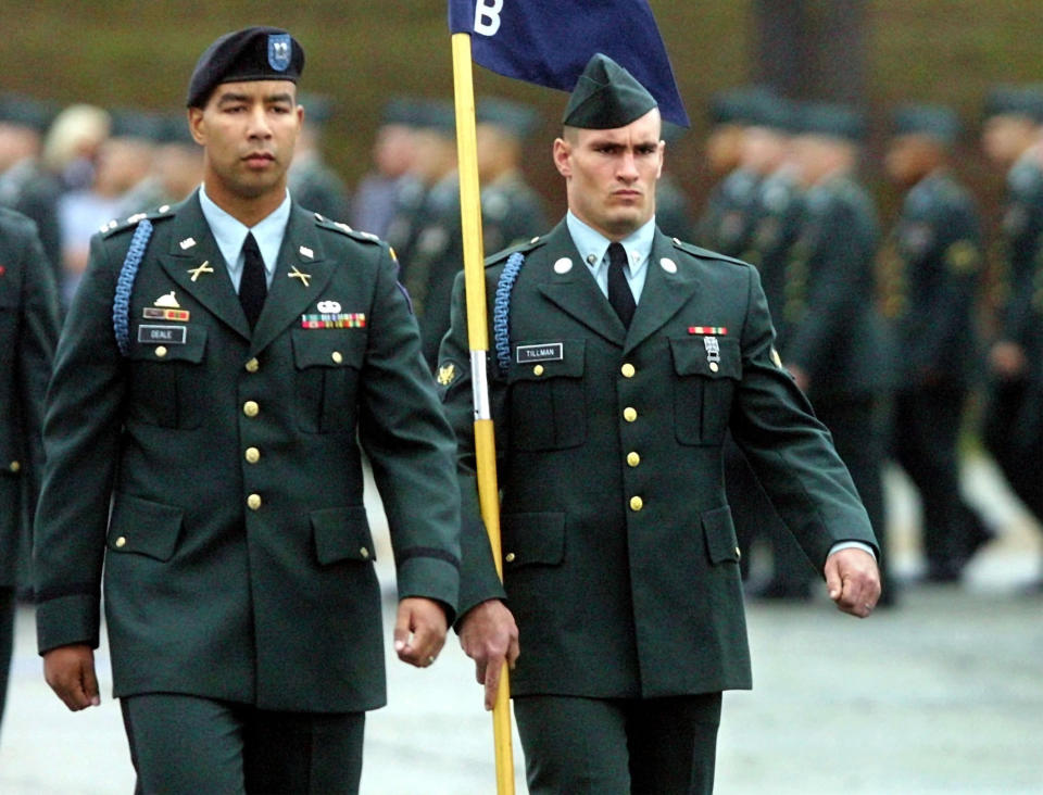 Specialist Pat Tillman, right, a former Arizona Cardinal, walks next to Captain Christoper Deale, company commander of B Company 1st BN 19th Infantry Regiment, during graduation ceremonies on October 25, 2002 at Fort Benning, Georgia. (Mike Haskey/Columbus Ledger-Enquirer)