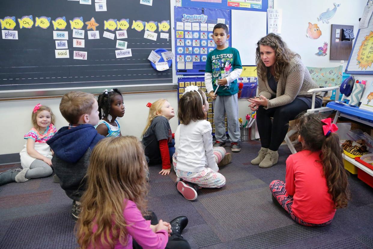 With the assistance of student Victor Martinez, kindergarten teacher Claire Brown reviews the calendar with class Wednesday, January 25, 2017, at Mayflower Mill Elementary.