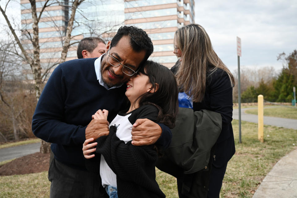 HERNDON, VA - FEBRUARY 09: Alejandra, 9, is embrace her father, Felix Maradiago after Felix is interviewed by the media after being released from a prison in Nicaragua and flown to the United States along with other political prisoners on Thursday February 09, 2023 in Herndon, VA. (Photo by Matt McClain/The Washington Post via Getty Images)