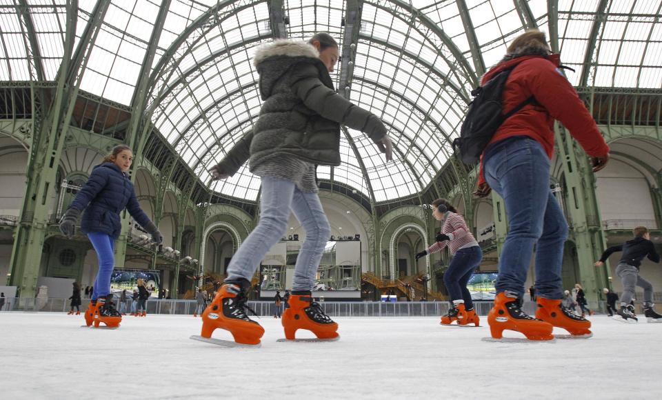 Skaters take advantage of the giant ice rink set up under the famous glass roof of the Grand Palais, in Paris Thursday Dec. 13, 2012. The Grand Palais skating rink is the largest temporary ice rink ever created in France. It will remain open until Jan. 6, 2013.(AP Photo/Remy de la Mauviniere)