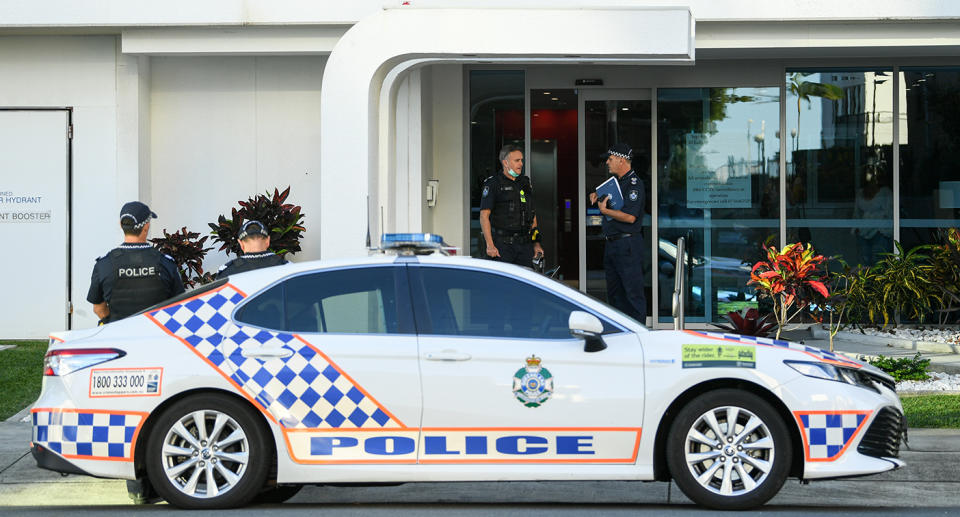 Queensland Police officers are seen outside an apartment building in Labrador, a coastal suburb of the Gold Coast, Friday, April 23, 2021. A man and a woman have been found dead at an apartment block on the Gold Coast. (AAP Image/Dave Hunt) NO ARCHIVING