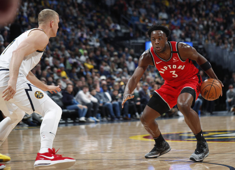 Toronto Raptors forward OG Anunoby, right, drives the lane as Denver Nuggets forward Mason Plumlee defends in the first half of an NBA basketball game Sunday, March 1, 2020. (AP Photo/David Zalubowski)