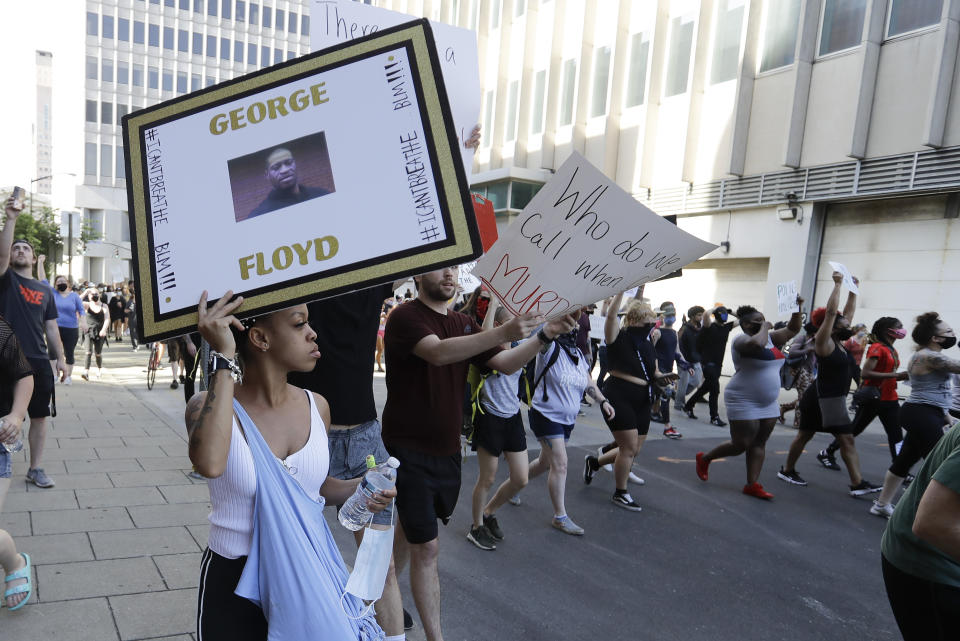 Kelly Bundy walks during a protest over the deaths of George Floyd and Breonna Taylor, Monday, June 1, 2020, in Louisville, Ky. Bundy of Louisville says most protesters are like her, peaceful people called to duty by experiences of racism and police aggression. (AP Photo/Darron Cummings)