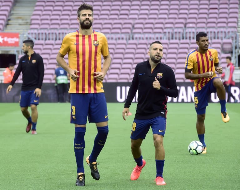 Barcelona's defenders Gerard Pique (2L) and Jordi Alba (2R) warm up on October 1, 2017