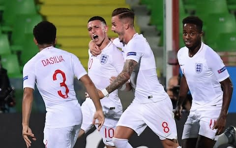 England's Phil Foden (2ndL) celebrates with teammates after opening the scoring during the Group C match of the U21 European Football Championships between England and France - Credit: Getty images