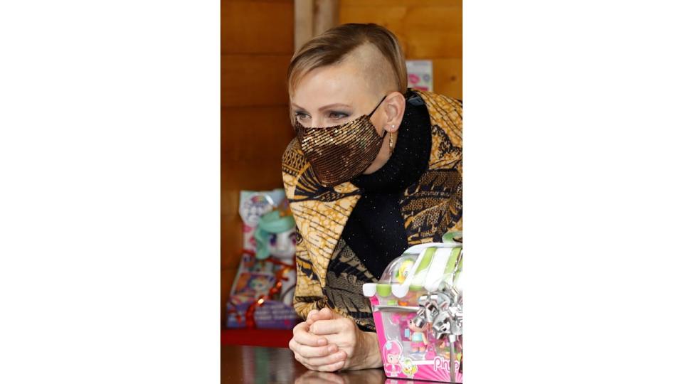 woman at christmas tree ceremony with shaved-head look 