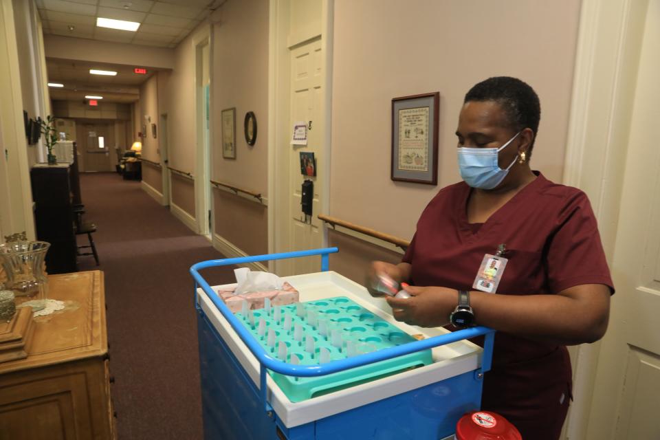 Vivian Townsend, a HHA at Vassar-Warner Senior Residence prepares her cart to distribute medicines on November 16, 2021.