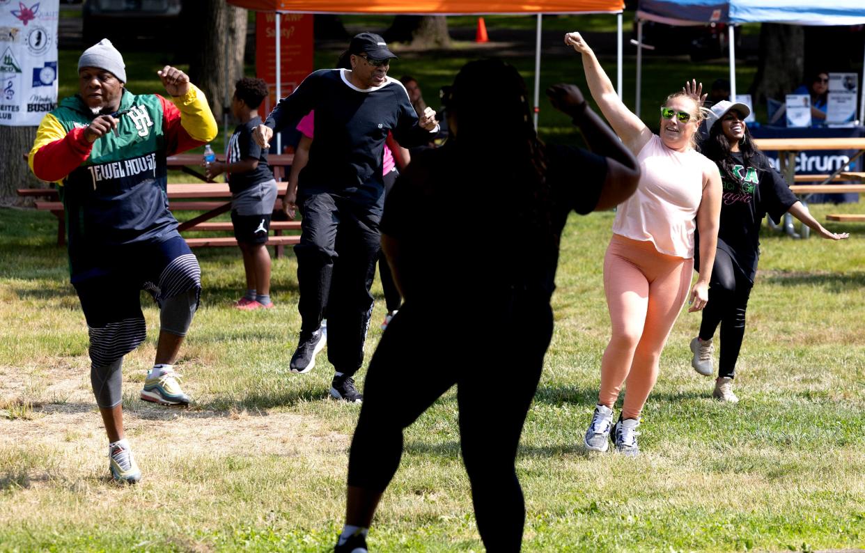 Ruselle' Pratt, in silhouette, leads a Zumba workout Saturday during the Juneteenth Community Festval at Nimisila Park in Canton.