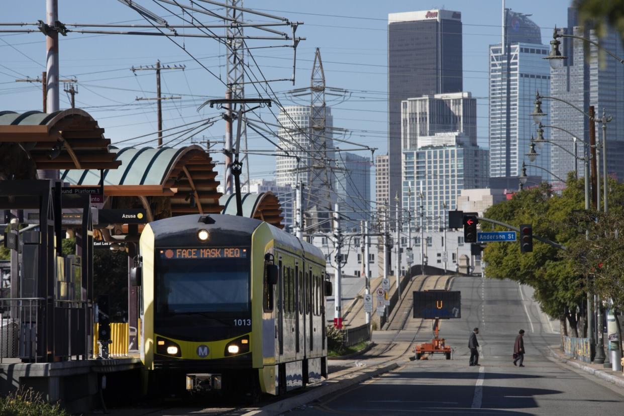 A light-rail train on a street.