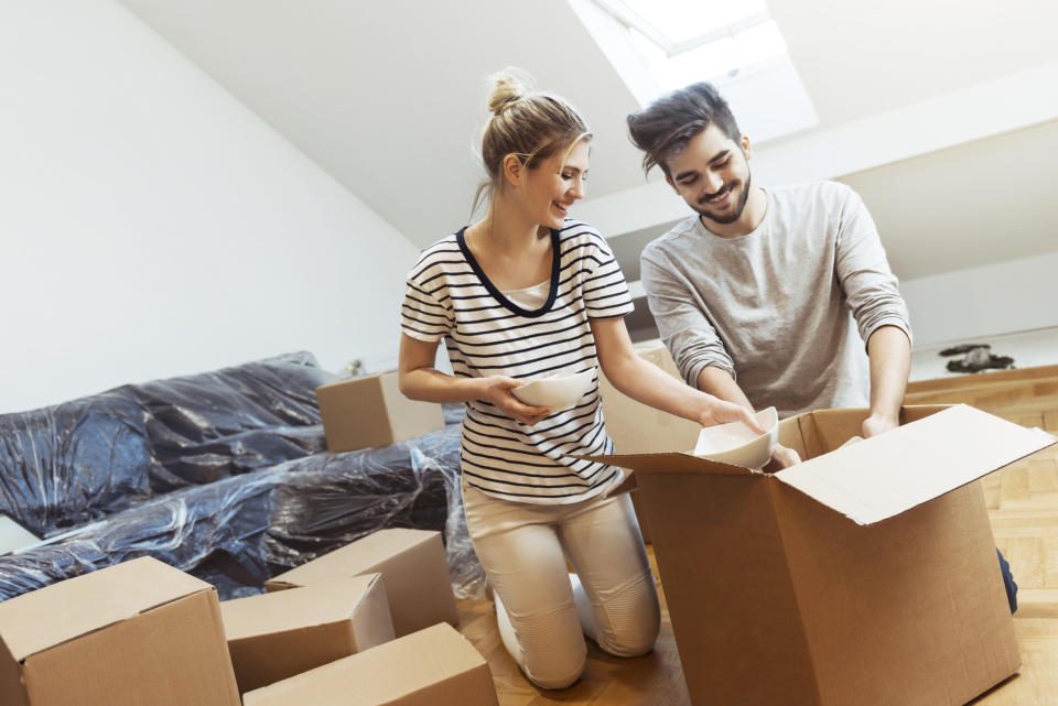 Young couple with moving boxes.