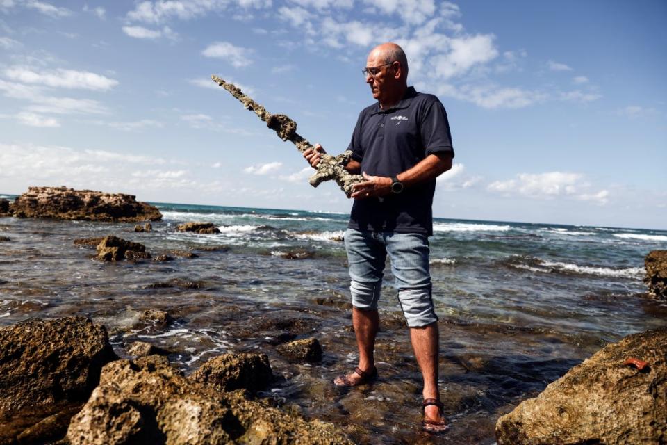 Yaakov Sharvit of the IAA holds a sword believed to have belonged to a Crusader who sailed to the Holy Land (REUTERS)