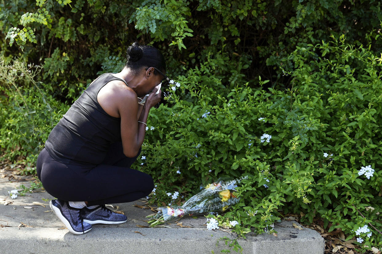Lisa, only first name given, grieves after placing flowers near the scene of a mass shooting at Cook's Corner, a biker bar in rural Trabuco Canyon, Calif., Thursday, Aug. 24, 2023. (Jae C. Hong / AP)