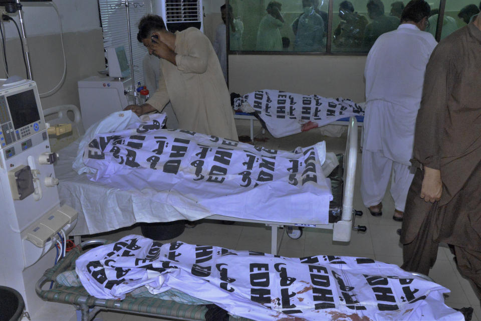 A Pakistani identifies body of his relative, who was died in a passenger train derailed incident, at a hospital, in Nawabshah, Pakistan, Sunday, Aug. 6, 2023. Railway officials say some passengers were killed and dozens more injured when a train derailed near the town of Nawabshah in southern Sindh province. (AP Photo/Pervez Masih)