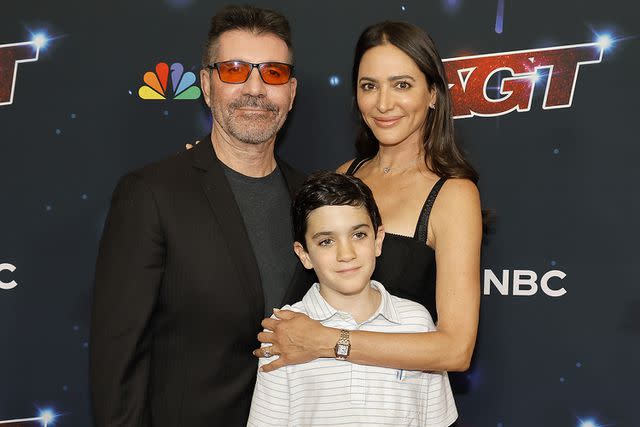 <p>Simon Cowell, Eric Philip Cowell, and Lauren Silverman attends the Red Carpet for "America's Got Talent" Season 18 Finale at Hotel Dena</p> Simon Cowell with son Eric and partner Lauren Silverman