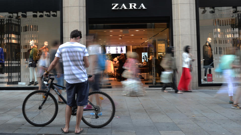 FILE - People walk past a Zara store in Barcelona, Spain, Wednesday, Aug. 27, 2014. Marta Ortega, the daughter of the founder of Spanish textile maker Inditex, which owns the Zara clothes store chain, will become its next chairwoman, the company said Tuesday. (AP Photo/Manu Fernandez, File)