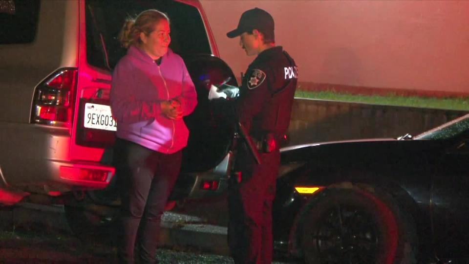 <div>Police talk to a woman after a double homicide in Napa on Riverside Drive on April 13, 2024.</div>