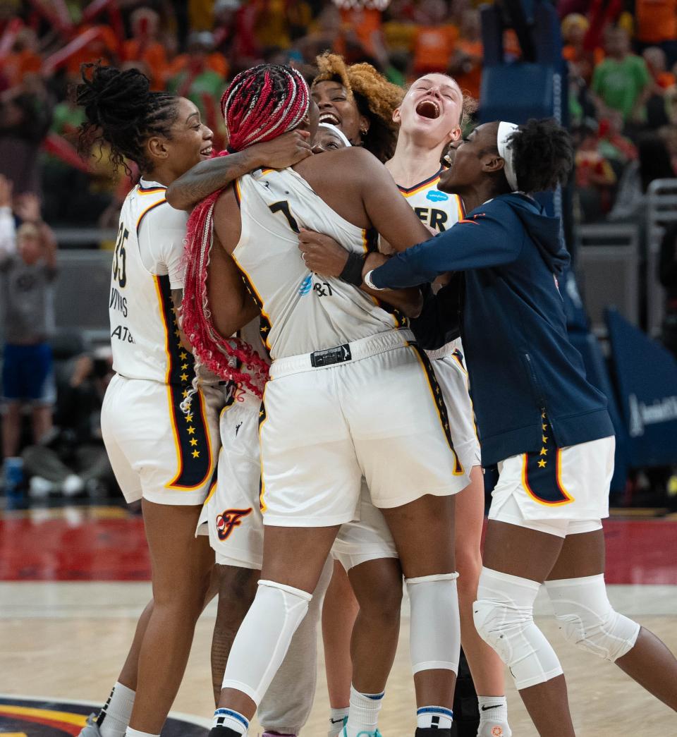 The Indiana Fever celebrate with Aliyah Boston (7) after she makes a three-pointer to bring the game to overtime during their game against the New York Liberty Wednesday, July 12, 2023 in Gainbridge Fieldhouse in Indianapolis.