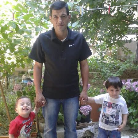 Abdullah Kurdi (C) poses with his sons Aylan (L) and Galip (R) in an undated photo provided by the Kurdi family. REUTERS/Kurdi family/Handout via Reuters