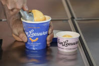 Ben Van Leeuwen scoops Kraft Mac & Cheese flavored ice cream Wednesday, May 15, 2024, in the Brooklyn borough of New York. Kraft Heinz approached New York-based artisanal ice cream maker Van Leeuwen a few years ago about macaroni and cheese-flavored ice cream. (AP Photo/Frank Franklin II)