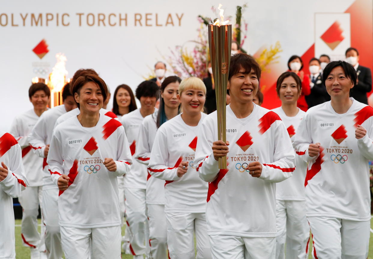 Tokyo 2020 Olympic Torch Relay Grand Start torchbearer Nadeshiko Japan, Japan's women's national soccer team, leads the torch relay in Naraha, Fukushima prefecture, Japan March 25, 2021. REUTERS/Kim Kyung-Hoon/Pool     TPX IMAGES OF THE DAY