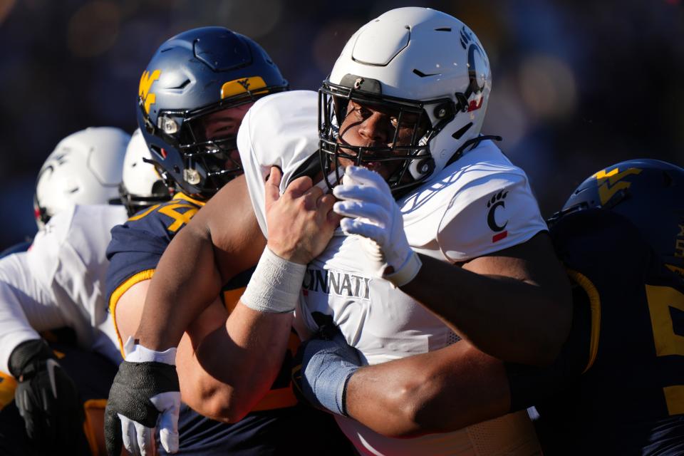 Cincinnati Bearcats defensive lineman Dontay Corleone (2) is back to fight off double teams as UC begins 2024 spring practice Monday.