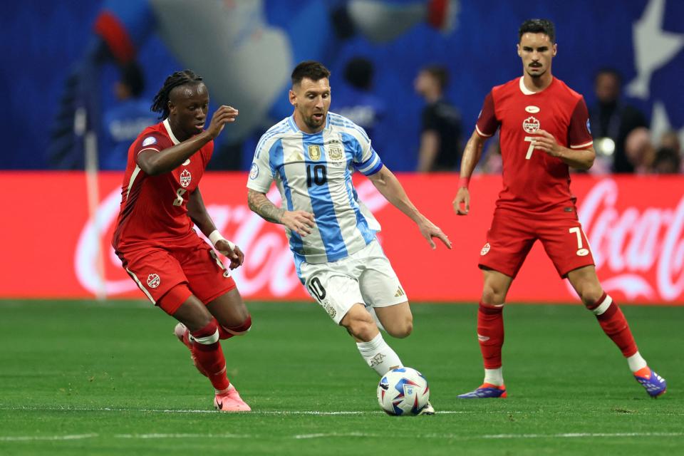 Canada's midfielder Ismael Kone (L) fights for the ball with Argentina's forward #10 Lionel Messi during the Copa America tournament group A football match between Argentina and Canada on June 20, 2024. (Photo by CHARLY TRIBALLEAU/AFP via Getty Images)
