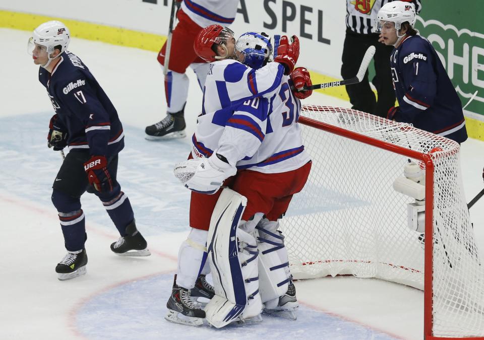 Russia's player Anton Slepyshev (2nd L) and Andrei Vasilevski react past U.S. team players Riley Barber (R) and Nicolas Kerdiles (L) in their IIHF Ice Hockey World Championship quarter-final match in Malmo, Sweden, January 2, 2014. REUTERS/Alexander Demianchuk (SWEDEN - Tags: SPORT ICE HOCKEY)