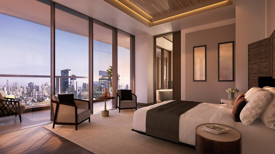 Aman Nai Lert Bangkok bedroom with a view of the cityscape.