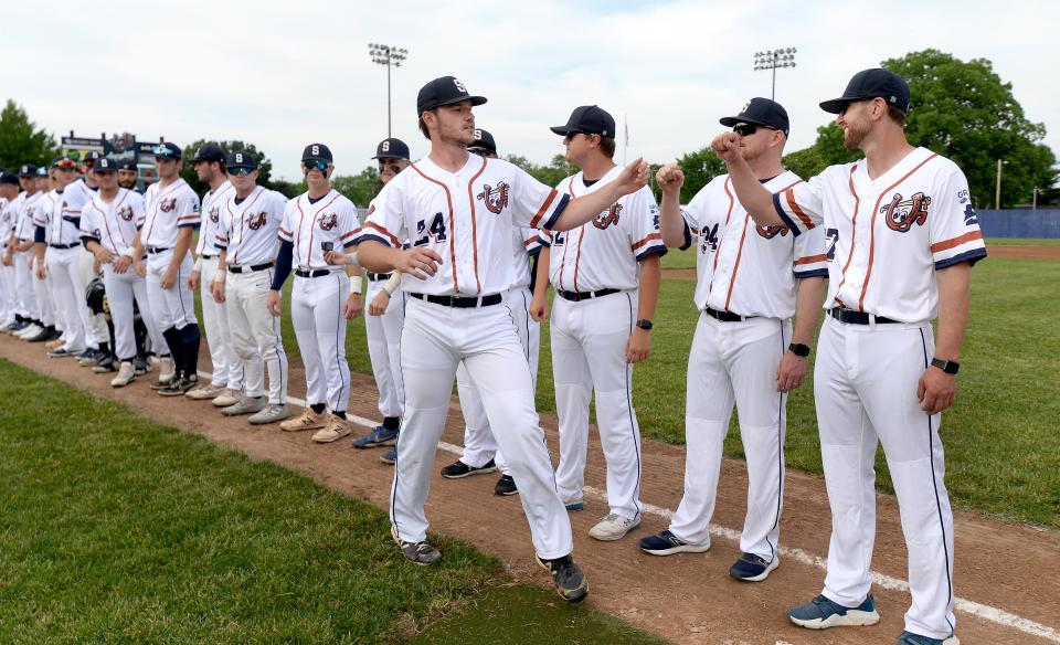 Lucky Horseshoe pitcher Gavin Bergman gives fist bumps to his teammates before the game at the team home debut game  Saturday June 4, 2022. [Thomas J. Turney/ The State Journal-Register]