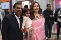 Chairman of Reliance Industries Limited Mukesh Ambani, with his wife Nita Ambani,holding their grand-daughter Aadiya attend the inauguration of the Indian House at the 2024 Summer Olympics, Saturday, July 27, 2024, in Paris, France. (AP Photo/Aurelien Morissard)