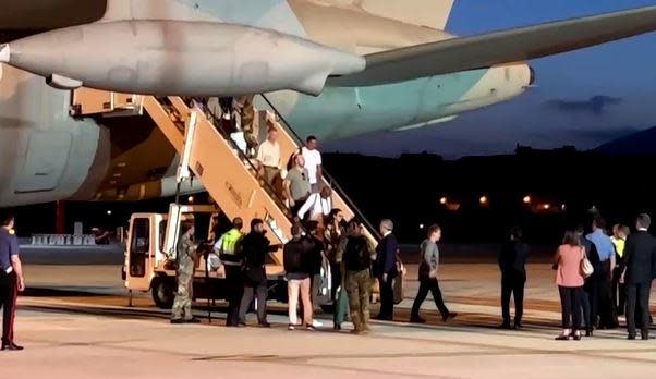 An image taken from video shows civilians, including 36 Italians, 21 Americans and one Briton, coming off a military plane that landed in Rome, Italy, early on August 2, 2023, as part of European evacuations from Niger following a coup in the African nation. / Credit: Reuters