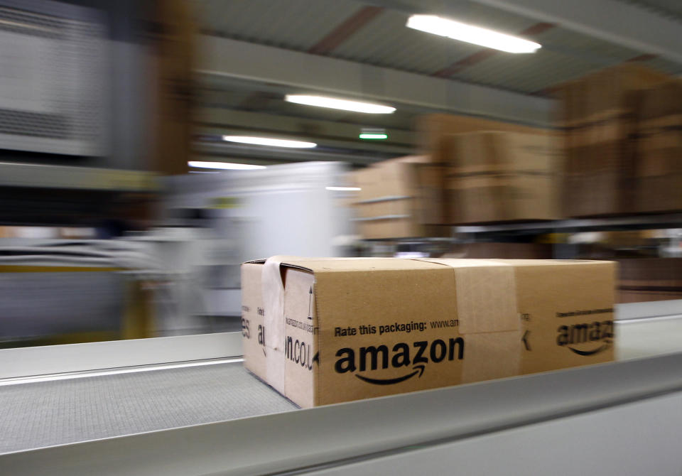 A parcel moves on the conveyor belt at Amazon's logistics centre in Graben near Augsburg December 16, 2013. Workers at Amazon.com's German operations were set to go on strike on Monday, in the middle of the crucial Christmas holiday season, in a dispute over pay that has been raging for months. The Verdi union said workers would strike in Amazon's logistic centres in Bad Hersfeld and Leipzig and, for the first time, in Graben. REUTERS/Michaela Rehle (GERMANY - Tags: BUSINESS EMPLOYMENT)