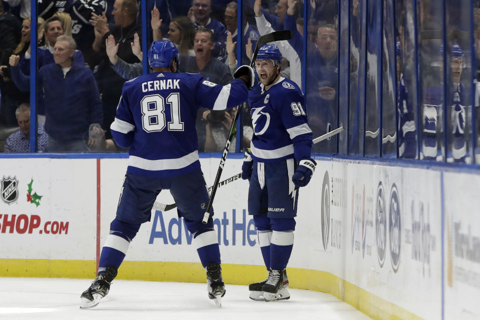 Tampa Bay Lightning center Steven Stamkos (91) celebrates his goal against the Boston Bruins with defenseman Erik Cernak (81) during the third period of an NHL hockey game Thursday, Dec. 12, 2019, in Tampa, Fla. (AP Photo/Chris O'Meara)