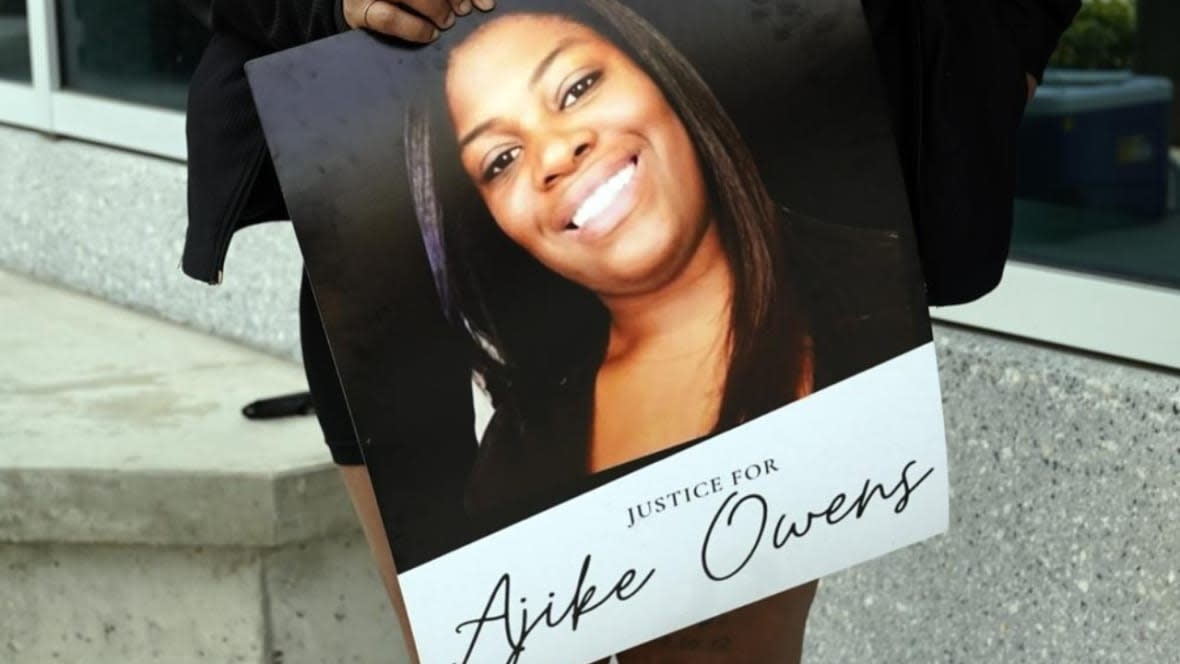 A protester, holds a poster of Ajike Owens at the Marion County Courthouse Tuesday in Ocala, Florida, demanding the arrest of a woman who shot and killed the 35-year-old mother of four last Friday night, June 2. (Photo: John Raoux/AP)