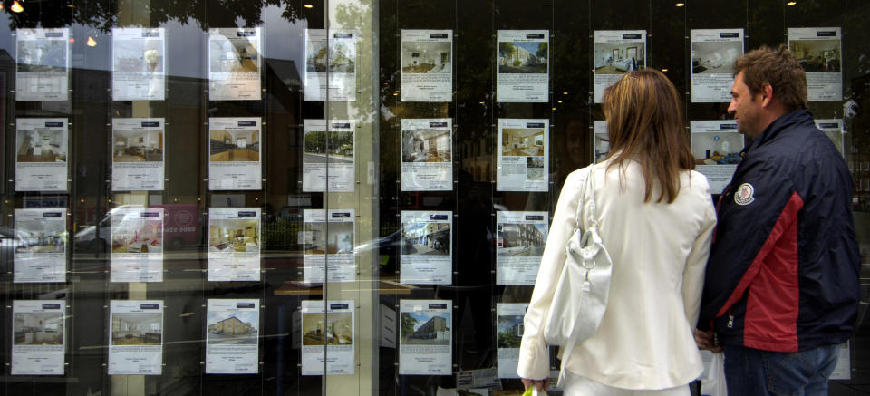 Stamp Duty A person walks past an estate agent's window in London after the Chancellor announced that homes worth £175,000 or less are to be exempted from stamp duty for 12 months as part of a package to revive the housing market.