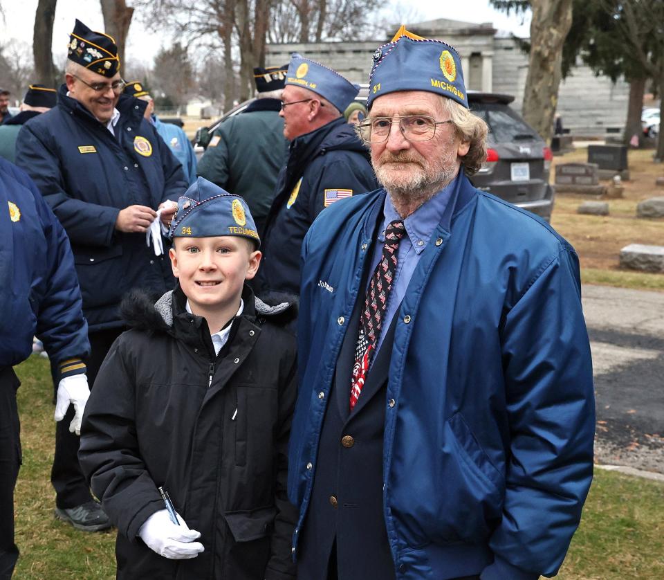 Easton Hurley, left, poses for a photo with veteran John Beeman on Saturday, Dec. 16, 2023, during a Wreaths Across America ceremony in Tecumseh at Brookside Cemetery.