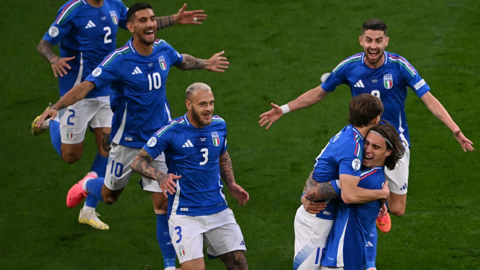 Barella celebrates with his teammates after scoring Italy's second. - Ozan Kose/AFP/Getty Images